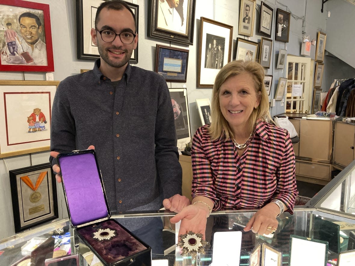 Zachary Diaz, left, and Elizabeth Haynie Wainstein, of The Potomack Compan,y display items from the estate of Gen. Colin Powell on Thursday, Nov. 3, 2022, in Alexandria, Va. (AP Photo/Matthew Barakat)