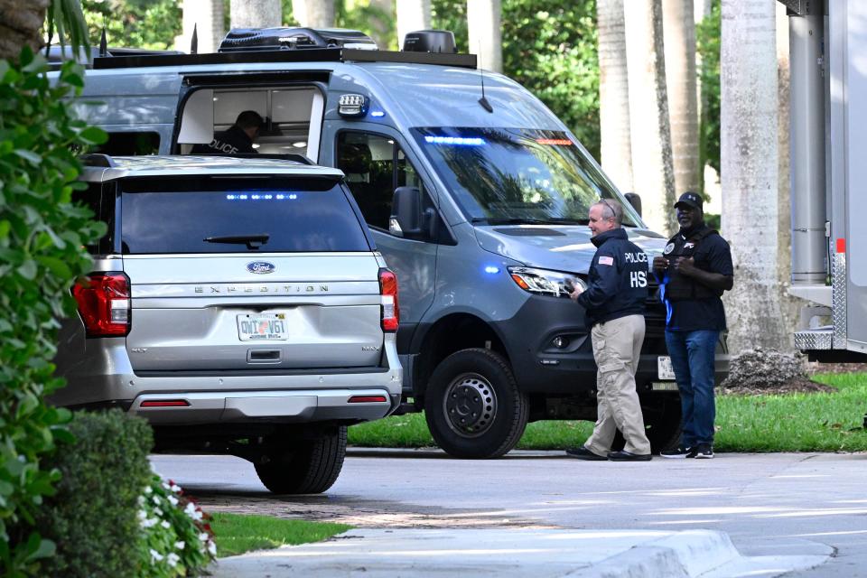 Police and Homeland Security officers are seen at the waterfront mansion of Sean Combs, a.k.a. Diddy, in Miami during a bicoastal raid on March 25, 2024, in Miami Beach, Florida.