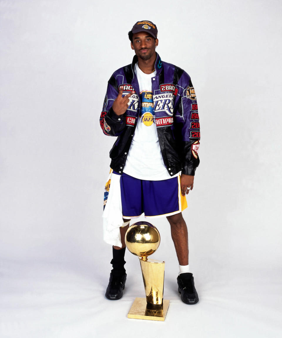 Deuces, dude. Kobe strikes a pose with the 2001 NBA Championship trophy in a stylish victory jacket. (Photo: Getty Images)