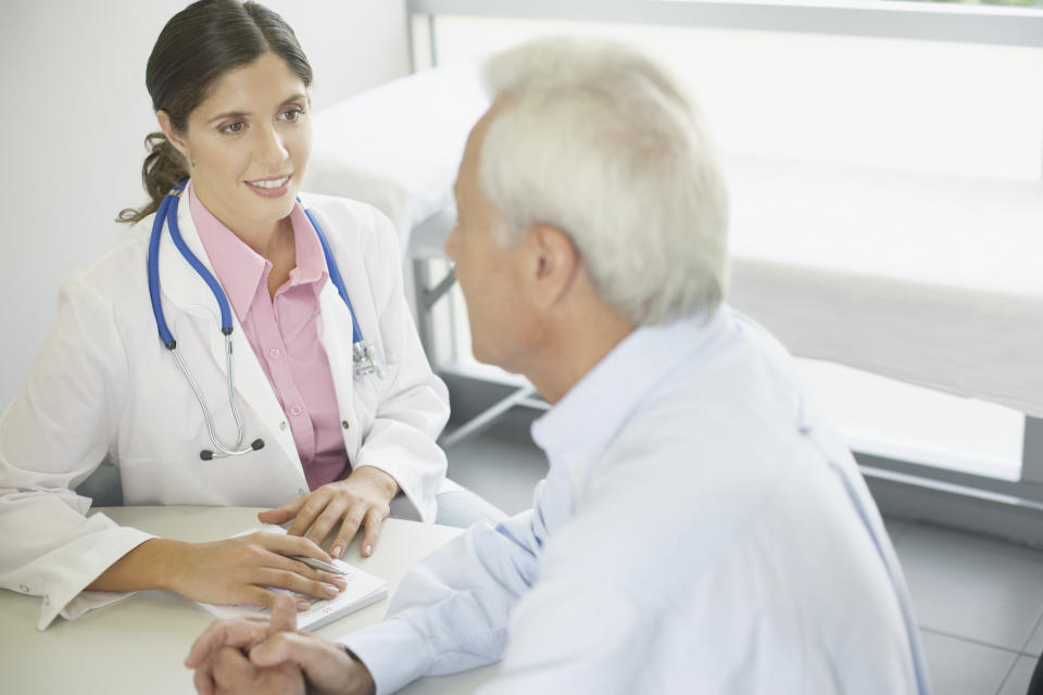 Doctor sitting at a table with a patient.