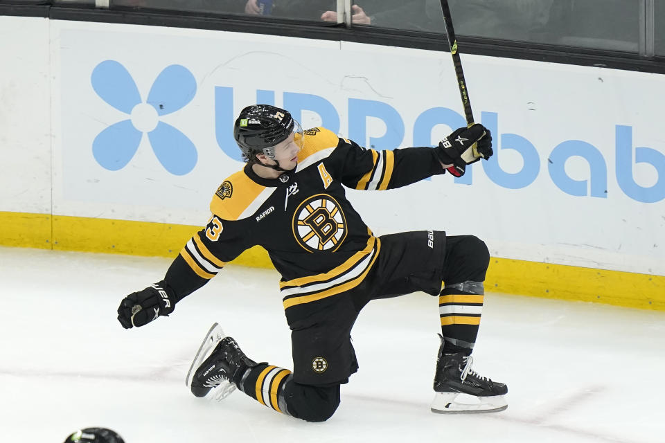Boston Bruins defenseman Charlie McAvoy celebrates after scoring in the second period of an NHL hockey game against the San Jose Sharks, Sunday, Jan. 22, 2023, in Boston. (AP Photo/Steven Senne)