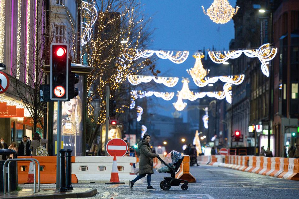 A woman with a pram on an almost empty Deansgate in Manchester city centre, as a new variant of COVID-19 keeps Christmas shoppers at home, on Monday 21st December 2020. (Credit: Pat Scaasi | MI News) (Photo by MI News/NurPhoto via Getty Images)