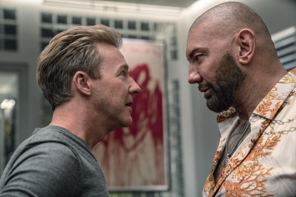 This image released by Netflix shows Edward Norton, left, and Dave Bautista in a scene from "Glass Onion: A Knives Out Mystery." (John Wilson/Netflix via AP)