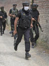 Members of Special Operations Group (SOG) of Jammu and Kashmir police arrive at the site of an attack on policemen on the outskirts of Srinagar, Indian controlled Kashmir, Friday, Aug. 14, 2020. Anti-India rebels in Indian-controlled Kashmir Friday attacked a police party in the disputed region's main city, killing two police officials and injuring another, police said. (AP Photo/Mukhtar Khan)