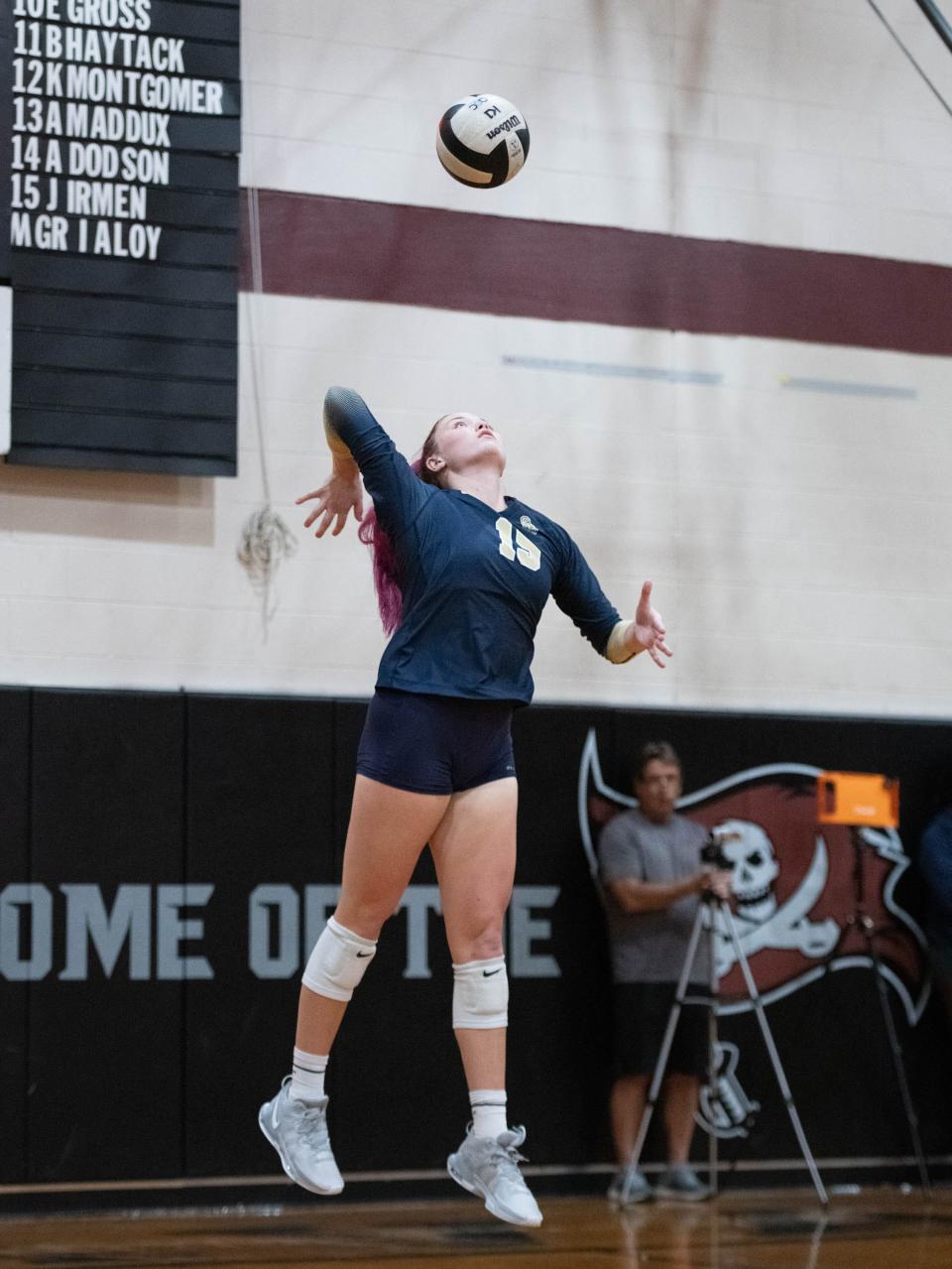 Bella Satterwhite (15) serves the ball during the Gulf Breeze vs Navarre volleyball match at Navarre High School on Tuesday, Sept. 12, 2023.