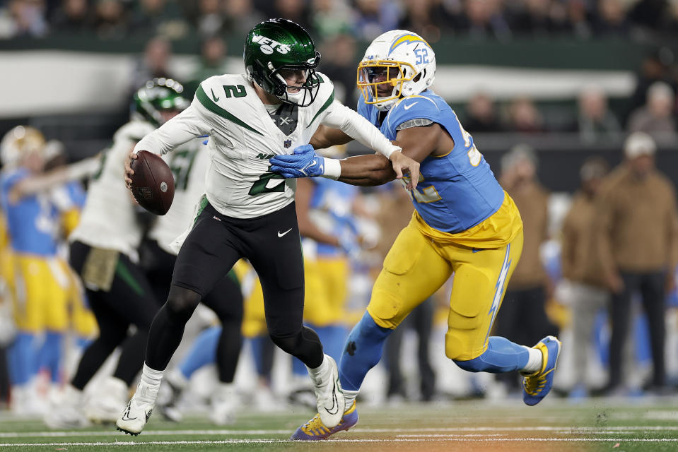 New York Jets quarterback Zach Wilson (2) scrambles against Los Angeles Chargers linebacker Khalil Mack (52) during the third quarter of an NFL football game, Monday, Nov. 6, 2023, in East Rutherford, N.J. (AP Photo/Adam Hunger)