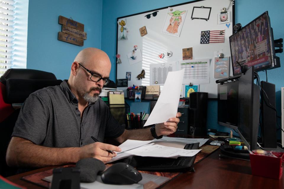 Jaime Lugo, the executive director at the Deaf and Hard of Hearing Center, works on payroll at his desk on Wednesday, Oct. 25, 2023, in Corpus Christi, Texas.