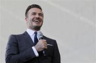 David Beckham laughs as he discusses matters related to the ownership position he has with a proposed Major League Soccer (MLS) expansion team that could play in Miami, at a news conference in Miami, Florida February, 5, 2014. REUTERS/Andrew Innerarity