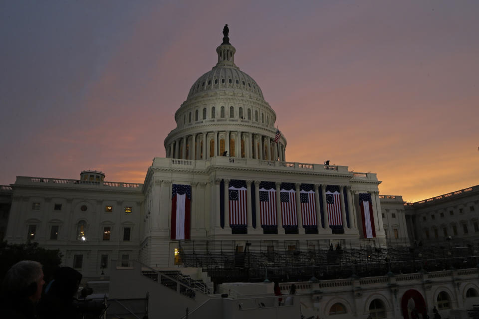 The sun rises behind the U.S. Capitol Dome early in the morning before the ceremonial swearing-in of President Barack Obama during the 57th Presidential Inauguration in Washington, Monday, Jan. 21, 2013. (AP Photo/Paul Sancya)