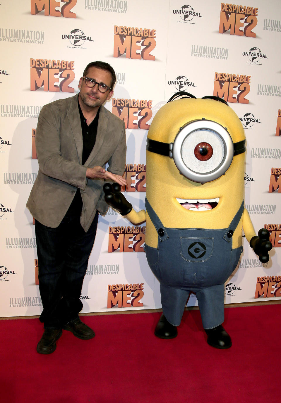 Actor Steve Carrell poses for photos with a character from "Despicable Me 2" as he walks the red carpet during the film's Australian premiere in Sydney, Australia, Wednesday, June 5, 2013. (AP Photo/Rob Griffith)