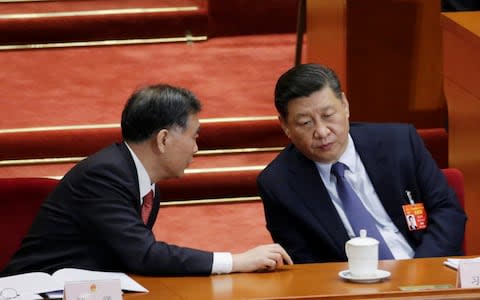 Chinese President Xi Jinping listens to Wang Yang during the opening session of the National People's Congress - Credit: &nbsp;JASON LEE/Reuters