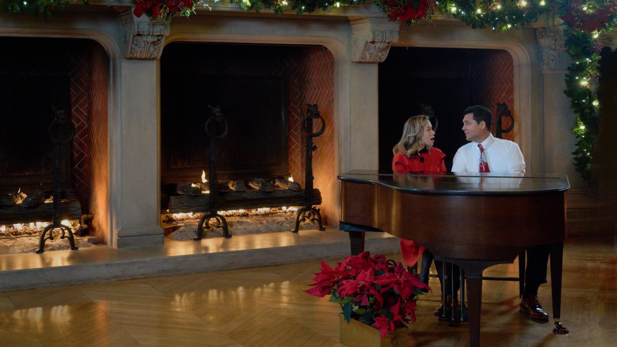  Bethany Joy Lenz and Kristoffer Polaha at a piano in A Biltmore Christmas. 