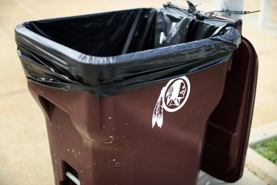 A trash can featuring the old Washington Redskins logo that has since been retired.