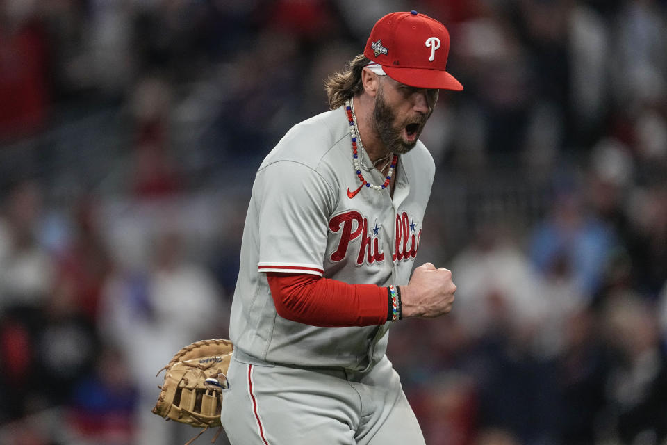 Philadelphia Phillies designated hitter Bryce Harper (3) reacts to a double play against the Atlanta Braves during the eighth inning of Game 1 of a baseball NL Division Series, Saturday, Oct. 7, 2023, in Atlanta. (AP Photo/John Bazemore)