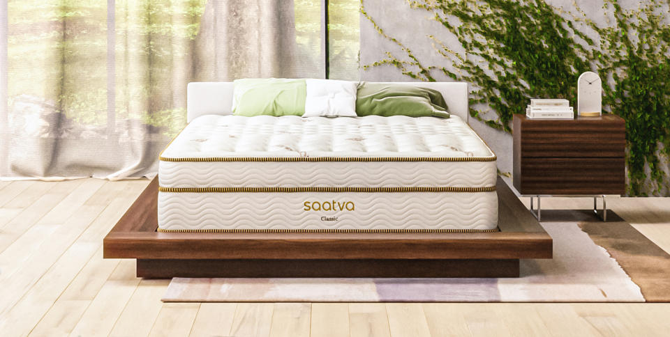 Image shows the Saatva Classic Mattress on a dark wooden bed frame