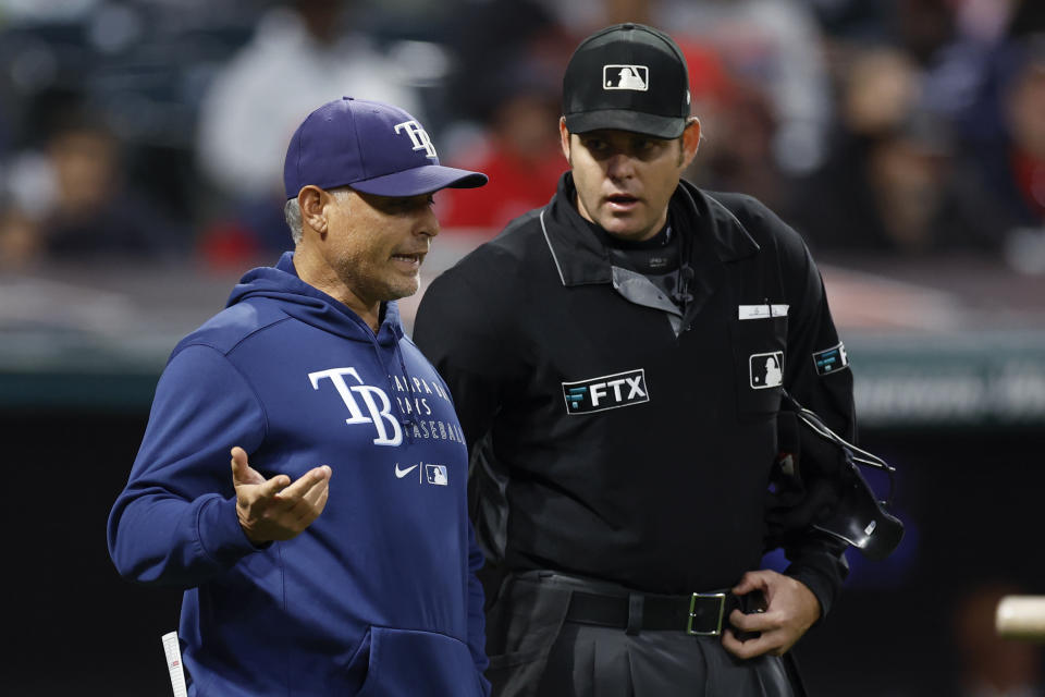 Tampa Bay Rays manager Kevin Cash discusses a call with home plate umpire Ryan Additon during the fourth inning of a baseball game against the Cleveland Guardians, Wednesday, Sept. 28, 2022, in Cleveland. (AP Photo/Ron Schwane)