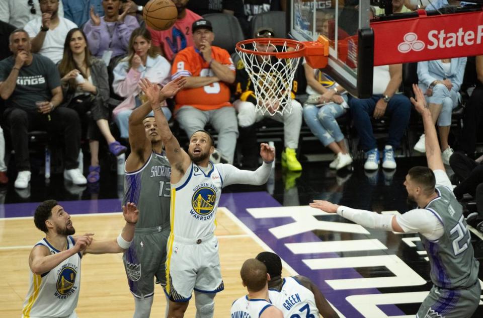 Golden State Warriors guard Stephen Curry (30) and Sacramento Kings forward Keegan Murray (13) battle for rebound during Game 5 of the first-round NBA playoff series at Golden 1 Center on Wednesday.