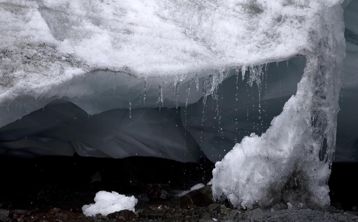 FILE - Water droplets drip from a block of ice of the Pastoruri glacier in Huaraz, Peru on Aug. 12, 2016. As glaciers melt and pour massive amounts of water into nearby lakes, 15 million people across the globe live under the threat of a sudden and deadly outburst flood, a new study finds. (AP Photo/Martin Mejia, File)