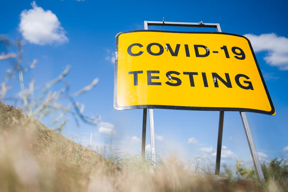 MANSTON, ENGLAND - AUGUST 04: A traffic sign directs people towards the temporary testing centre on the site at Manston Airport on August 04, 2020 in Manston, England. A group of Britain's leading virus experts have written to the government, expressing their frustration at the mistakes being made in the country's response to the COVID-19 pandemic. In the letter, signed by nearly 70 clinical virologists, they state that “Our skills have been underused and underrepresented (albeit to differing extents within the devolved nations of the UK), resulting in lost opportunities to establish a coordinated robust and durable testing framework for Sars-CoV-2.” (Photo by Leon Neal/Getty Images)