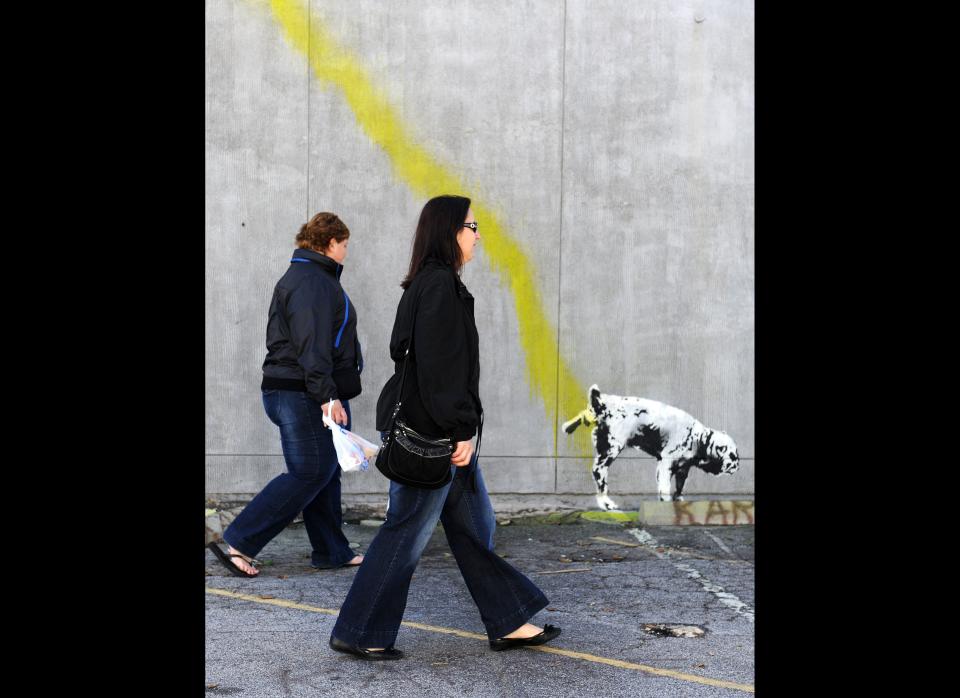 A graffiti attributed to secretive British artist Banksy shows a dog urinating on a wall in Beverly Hills, California on February 17, 2011. Another graffiti was ripped down Wednesday, February 16th  in Hollywood, amid sightings of other pieces in a reported pre-Oscars publicity stunt. Banksy is nominated for best documentary for 'Exit Through the Gift Shop' at the Oscars, due to be announced on February 27th at the climax of Tinseltown's annual awards season.  AFP PHOTO / GABRIEL BOUYS (Photo credit should read GABRIEL BOUYS/AFP/Getty Images)