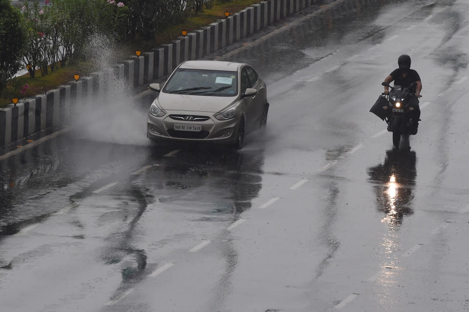 Commuters drive along Marine Drive as rain falls in Mumbai on June 3, 2020. (Photo by PUNIT PARANJPE/AFP via Getty Images)