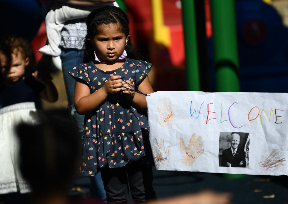 A child holda a banner welcoming US President Joe Biden to the Capitol Child Development Center in Hartford, Connecticut, on October 15, 2021. (Brendan Smialowski/AFP via Getty Images)