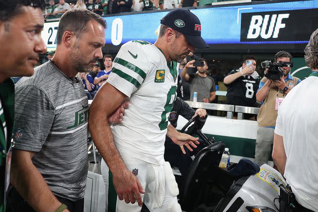 <p>Elsa/Getty Images</p> Quarterback Aaron Rodgers #8 of the New York Jets is helped off the field