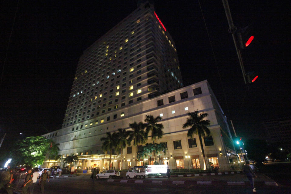 The Traders Hotel in Yangon, Myanmar Tuesday, Oct 15, 2013 following an explosion just before midnight Monday, which ripped apart a guest's room and slightly wounded an American woman in the latest in a series of unexplained blasts to hit the Southeast Asian country. It was not immediately clear what caused the explosion but the incident came after unidentified assailants planted three homemade bombs in and around Yangon in recent days, reportedly killing two people and injuring three others. (AP Photo/Khin Maung Win)