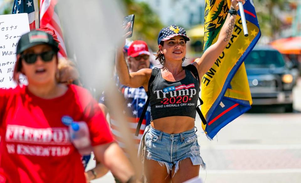 Aly Garcia, center, participates in an ÒEnd Of The Pandemic March South FloridaÓ rally in Las Olas Beach in Fort Lauderdale, Florida on Saturday, August 15, 2020.
