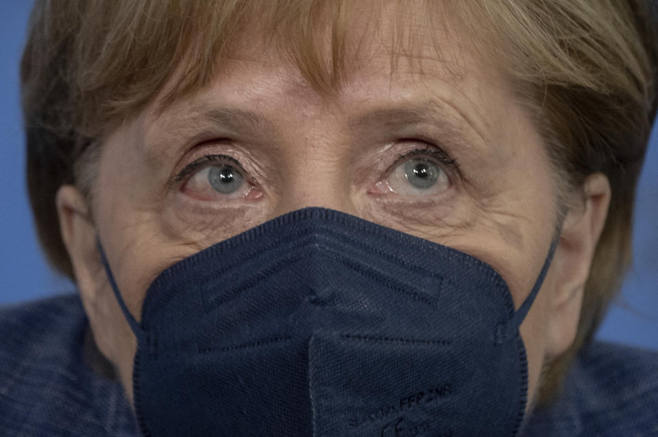 German Chancellor Angela Merkel stands up with mask after the press conference following her visit to the Robert Koch Institute (RKI) in Berlin, Germany, Tuesday, July 13, 2021. Merkel visited the health ministry's leading institute in the Corona pandemic at the invitation of Health Minister Spahn. (Michael Kappeler/Pool via AP)