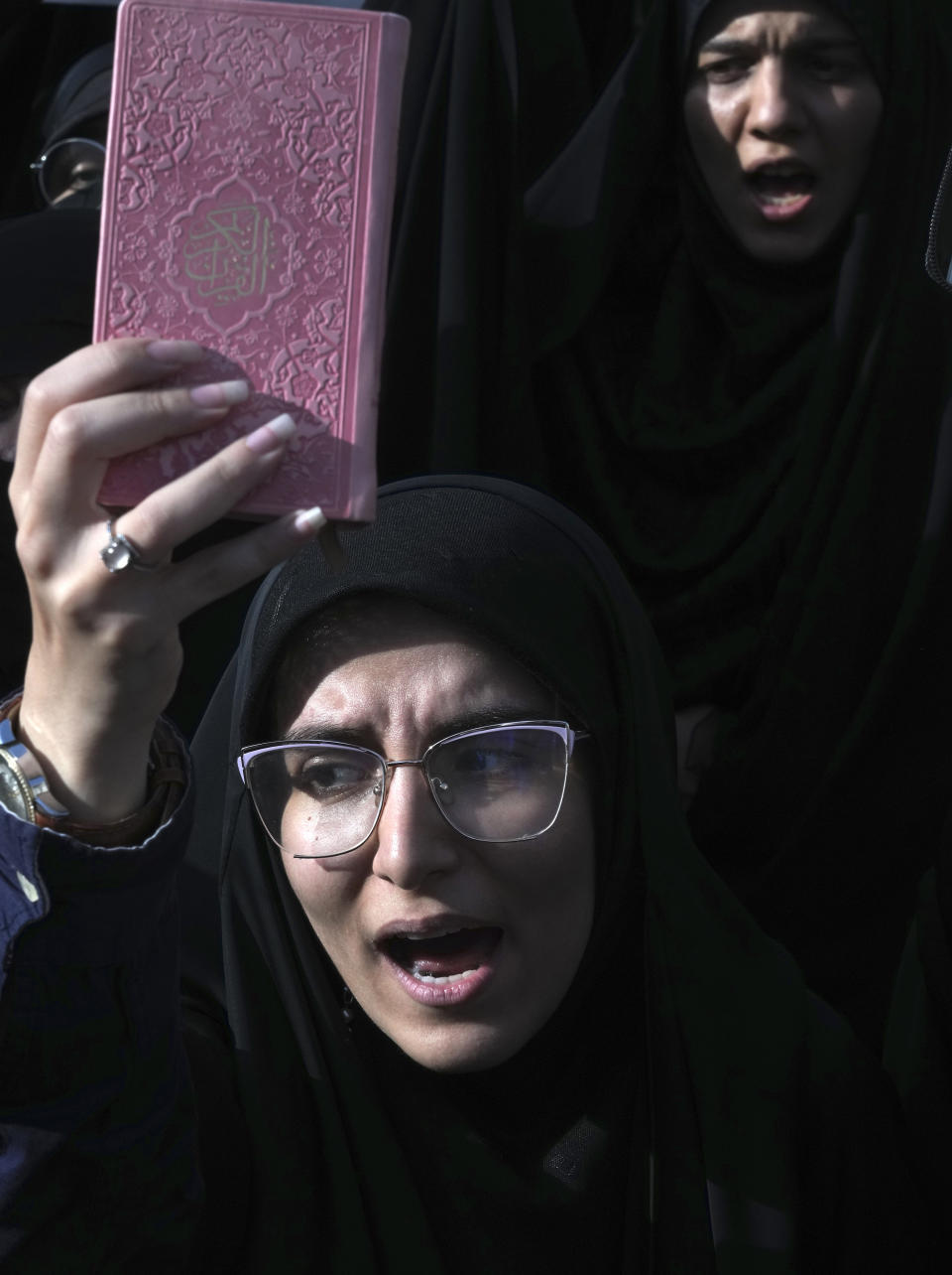 A protester holds up a copy of Muslim's holy book, the Quran, in a protest against Sweden in front of the Swedish Embassy in Tehran, Iran, Friday, July 21, 2023. Thousands of people took to the streets in a handful of Muslim-majority countries Friday to express their outrage at the desecration of a copy of the Quran in Sweden, a day after protesters stormed the country's embassy in Iraq. (AP Photo/Vahid Salemi)