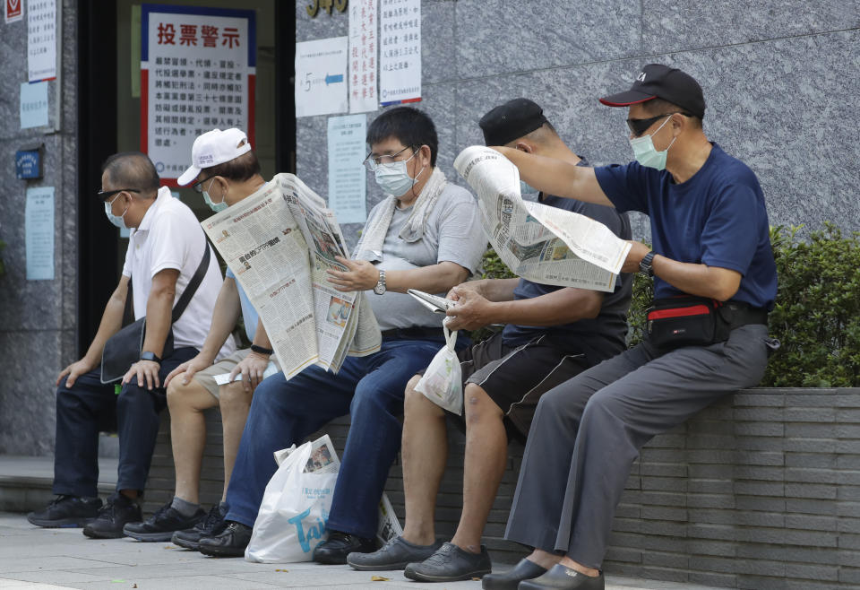 Members of the Nationalist Party, or KMT, wait to cast their ballot for the election of the party chairman at a polling station in Taipei, Taiwan, Saturday, Sept. 25, 2021. Fraught relations with neighboring China are dominating Saturday's election for the leader of Taiwan’s main opposition Nationalist Party. (AP Photo/Chiang Ying-ying)