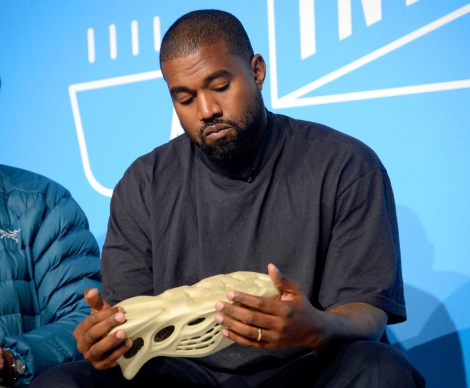 Kanye West holds a Yeezy shoe in 2019 (Getty Images for Fast Company)