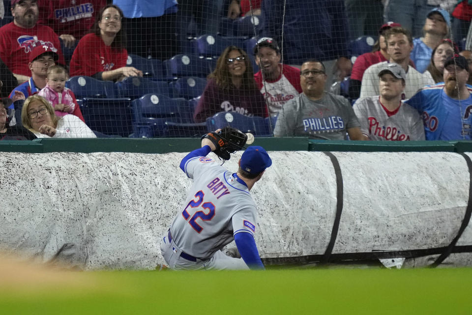 New York Mets third baseman Brett Baty cannot reach a pop foul by Philadelphia Phillies' Bryson Stott during the fifth inning of a baseball game, Sunday, Sept. 24, 2023, in Philadelphia. (AP Photo/Matt Slocum)