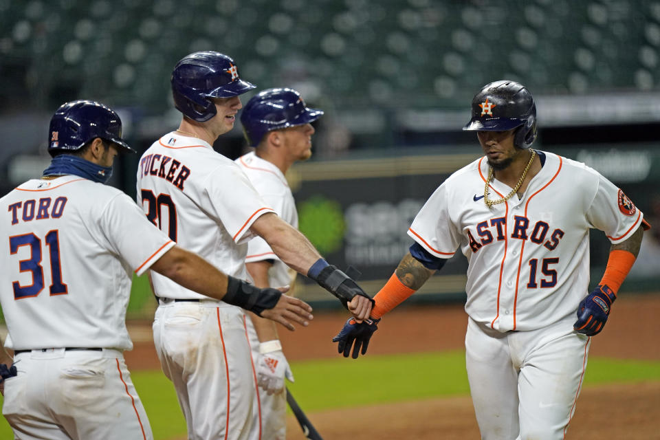 Houston Astros' Martin Maldonado (15) celebrates with Abraham Toro (31) and Kyle Tucker (30) after they all scored on Maldonado's home run against the San Francisco Giants during the sixth inning of a baseball game Wednesday, Aug. 12, 2020, in Houston. (AP Photo/David J. Phillip)