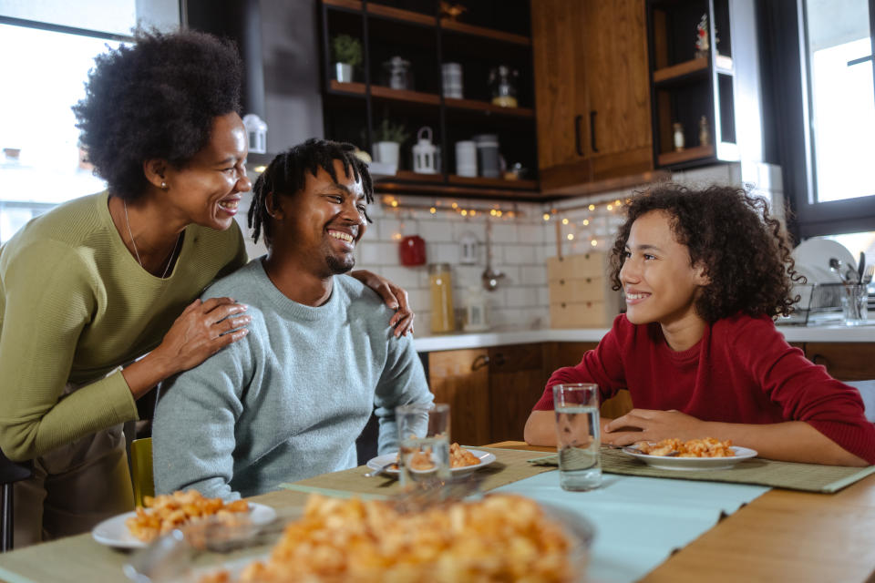 Shot of African American family spending time together and enjoying the dinner