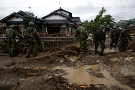 Japanese Self-Defense Force soldiers conduct search and rescue operation near houses damaged by a heavy rain in Asakura, Fukuoka Prefecture, Japan July 9, 2017. REUTERS/Issei Kato