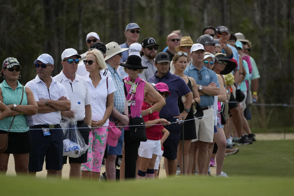 Spectators look on at the first hole green during the third round of the LPGA Tour Championship golf tournament, Saturday, Nov. 20, 2021, in Naples, Fla. (AP Photo/Rebecca Blackwell)