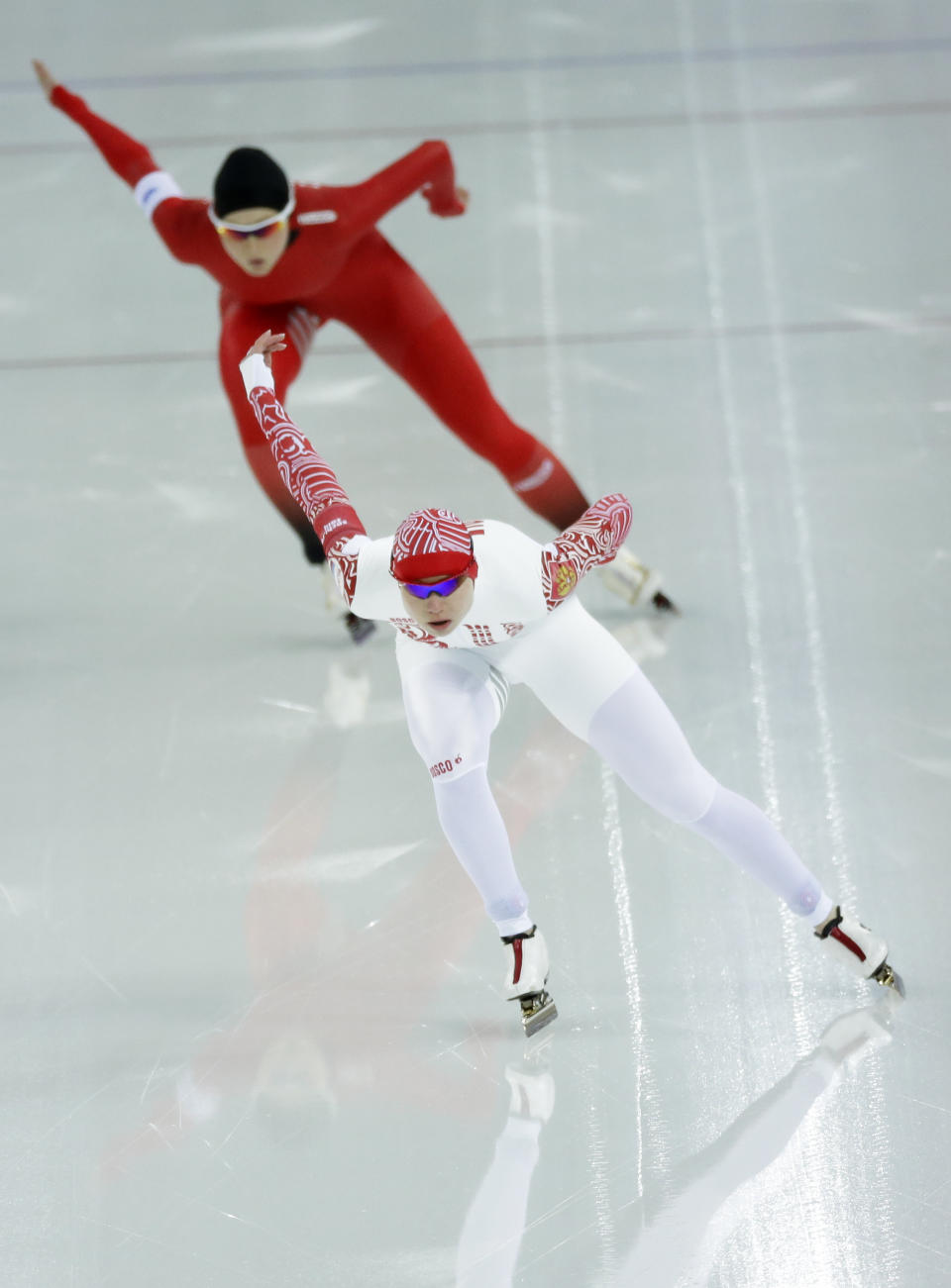 Norway's Hege Bokko, top, and Russia's Olga Fatkulina compete in the women's 1,500-meter race at the Adler Arena Skating Center during the 2014 Winter Olympics in Sochi, Russia, Sunday, Feb. 16, 2014. (AP Photo/David J. Phillip )