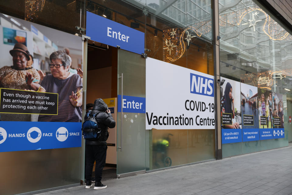 LONDON, ENGLAND - DECEMBER 05: A NHS Covid-19 vaccination centre at Westfield Stratford City on December 5, 2021 in London, England. Amid worries over the newly identified Covid-19 Omicron variant,  the UK has reintroduced mask-wearing and travel restrictions, but the centerpiece of its pandemic defence remains its vaccination programme, including an accelerated booster schedule. It has cut the recommended time between doses and said all adults will be eligible for boosters by the end of January.  (Photo by Hollie Adams/Getty Images)