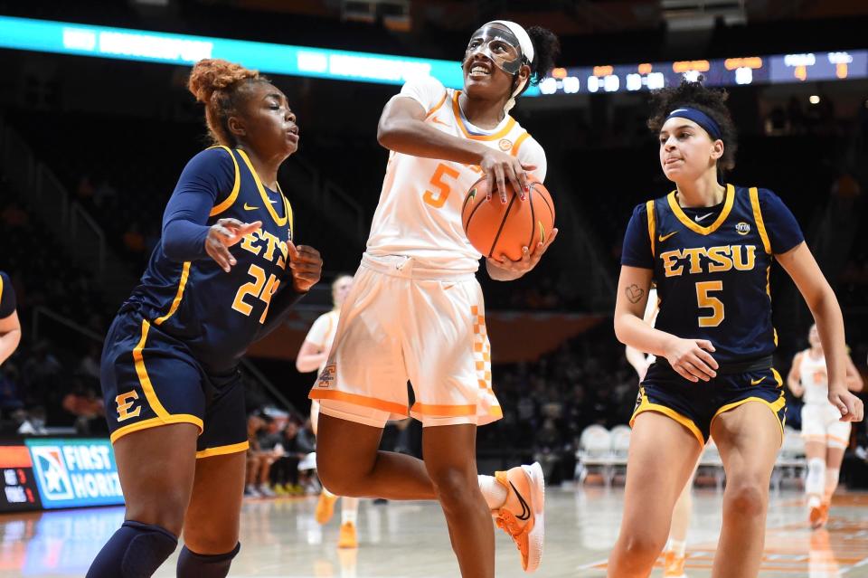 Tennessee guard Kaiya Wynn (5) attempts to score while guarded by ETSU center Jakhyia Davis (24) and guard/forward Abby Carrington (5) in the NCAA women's basketball game between the Tennessee Lady Vols and East Tennessee State Buccaneers in Knoxville, Tenn. on Monday, December 20, 2021. 