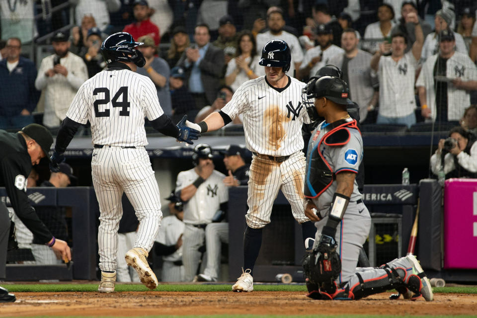New York Yankees' Alex Verdugo (24) is congratulated by Jon Berti, center right, after hitting a home run in the second inning of a baseball game, Tuesday, April 9, 2024, in New York. (AP Photo/Peter K. Afriyie)