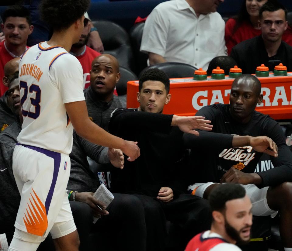 Apr 22, 2022; New Orleans, Louisiana, U.S.;  Phoenix Suns guard Devin Booker slaps hands with forward Cameron Johnson (23) during Game 3 of the Western Conference playoffs against the New Orleans Pelicans. Mandatory Credit: Michael Chow-Arizona Republic