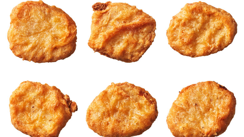 Frozen chicken nuggets on white background