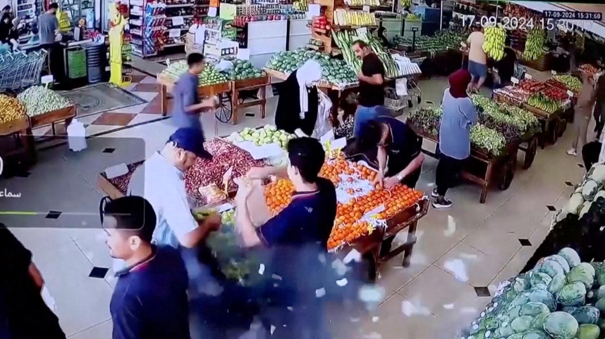 A man's bag explodes in a supermarket in Beirut on Tuesday.