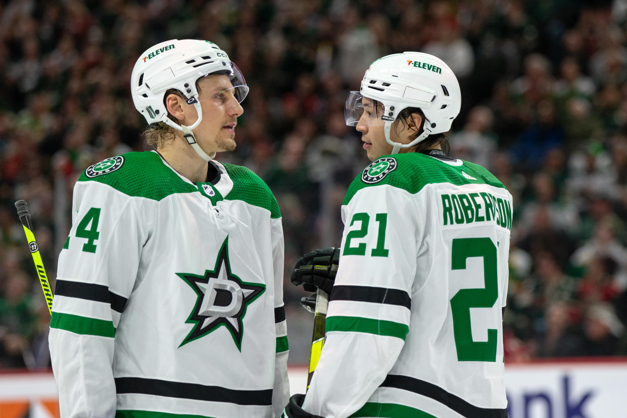 Dallas Stars left wing Jason Robertson (21) talks with Dallas Stars defenseman Miro Heiskanen (4) 