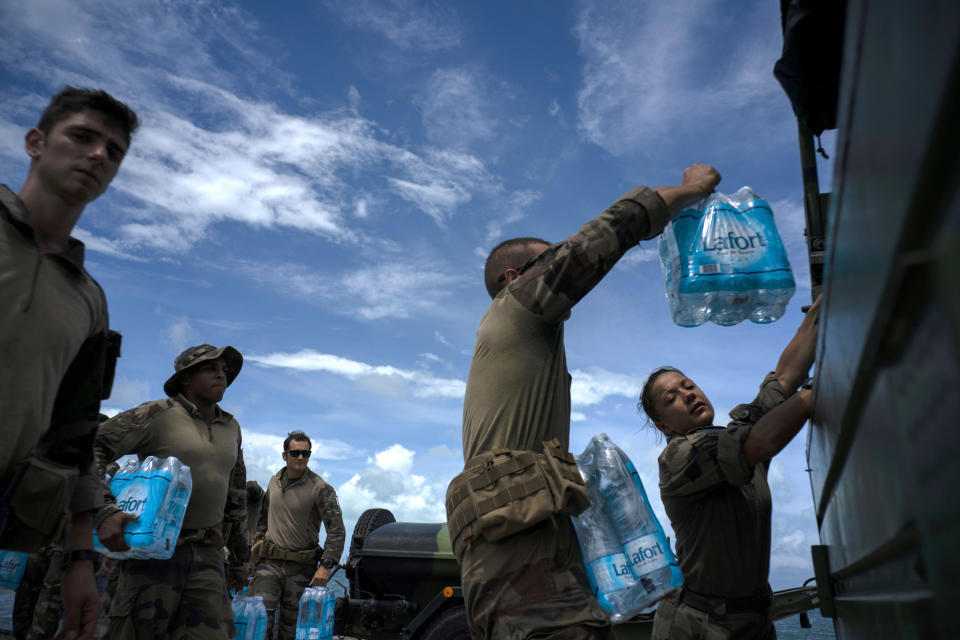 French soldiers load water to assist in the reconstruction in the aftermath of Hurricane Dorian in Abaco, Bahamas, Monday, Sept. 16, 2019. Dorian hit the northern Bahamas on Sept. 1, with sustained winds of 185 mph (295 kph), unleashing flooding that reached up to 25 feet (8 meters) in some areas. (AP Photo/Ramon Espinosa)