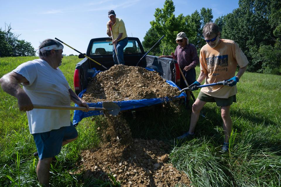 Johnny Holcomb, left, Brian Hall, Glen White and Mark Nason shovel dirt for future use following the first green burial at the Windy Knoll Memorial Sanctuary. Windy Knoll, in Lawrenceburg, is the first green cemetery in the state of Kentucky. A green burial means the body within the casket is not embalmed, and the casket is either made of wood or is simply a linen shroud. July 14, 2023