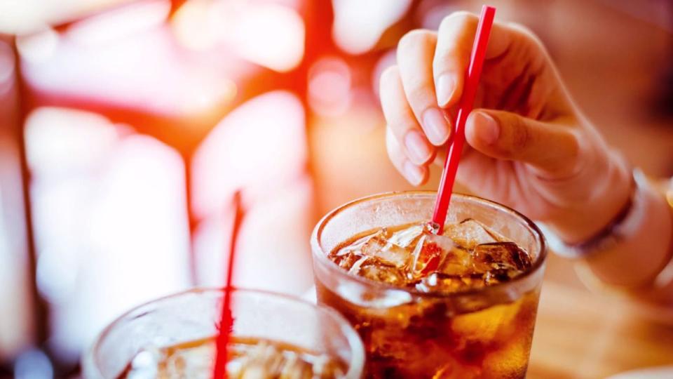 Stock image of person drinking soda