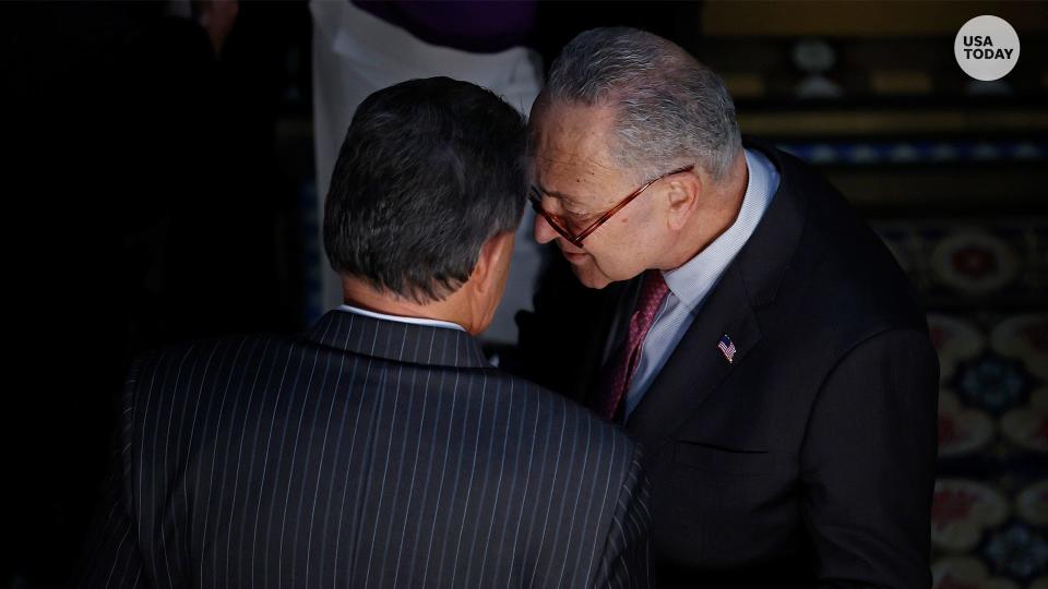 Sen. Joe Manchin (D-WV) (L) talks with Senate Majority Leader Charles Schumer (D-NY) before the ceremony where U.S. President Joe Biden signed the “Consolidated Appropriations Act" in the Eisenhower Executive Office Building on March 15, 2022 in Washington, DC.